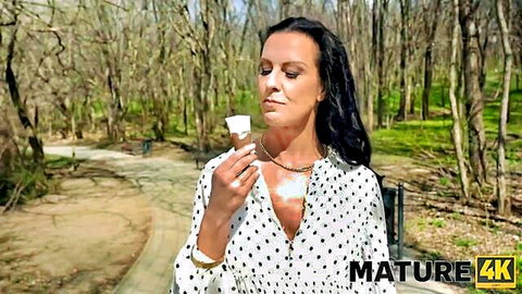 Texas Patti in polka dot blouse with cleavage, smelling treat in forest, Mature4K