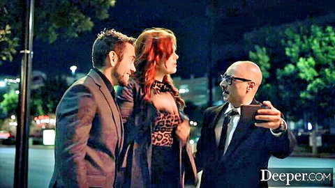 Maitland Ward in leopard top with suited men nighttime selfie