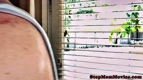 Stepmom in white tank top by window in nanny scene
