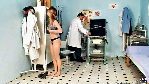 Blonde woman in black lingerie stands in gynecologist office with male doctor