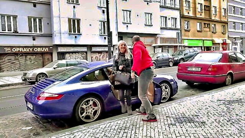 Liz Rainbow invited by George Uhl for private photo shoot beside blue Porsche