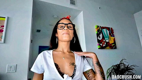 Brunette in glasses teases huge tits in lace bra smiling seductively