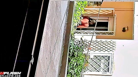 Surprised neighbor woman in red top peeking from window, amateur reaction
