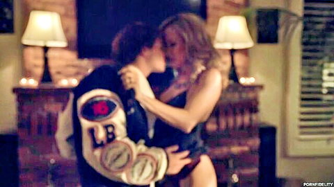 Tanned blonde MILF with big tits passionately kisses athletic guy in leather jacket