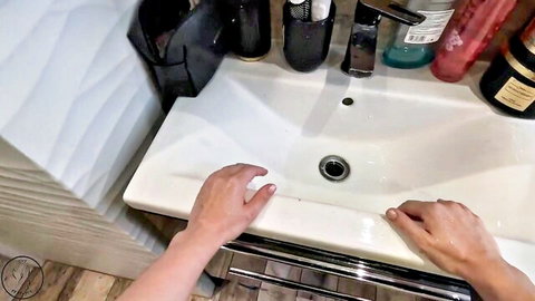 Woman's hands gripping sink in Polish neighbor plumber fantasy