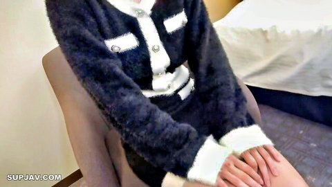 Seductive Japanese woman in fluffy black and white blazer sitting on chair