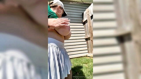Blonde thicc woman flashing huge tits outdoors in tennis skirt