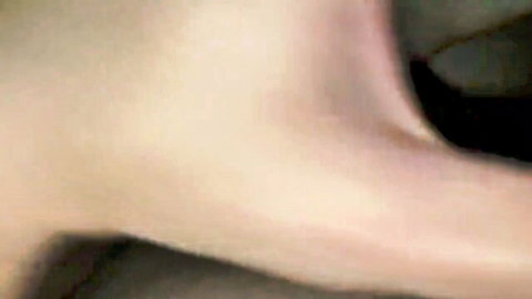 Blurry closeup of smooth pale skin curves on woman's thigh or ass