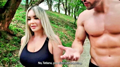 Kourtney Love with muscular coach outdoors, blonde in black tank top