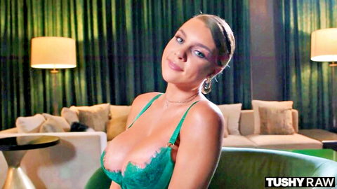 Gabbie Carter in revealing green lingerie, seductive pose on couch