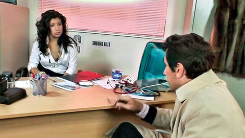 Brunette secretary in white blouse at office desk with colleague