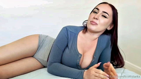 Thick brunette in gray top and panties teases with huge tits cleavage and juicy ass on bed