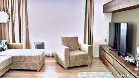 Empty modern living room interior with beige sofa, armchairs, TV stand and curtains