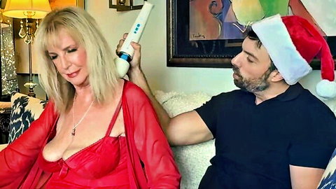 Blonde MILF's huge tits exposed in sheer red lingerie as Santa holds vibrator on her neck