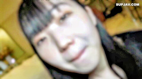 Close-up of smiling Asian woman with black bangs in amateur JAV video
