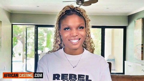 Smiling ebony blonde with braids in white Rebel t-shirt casting