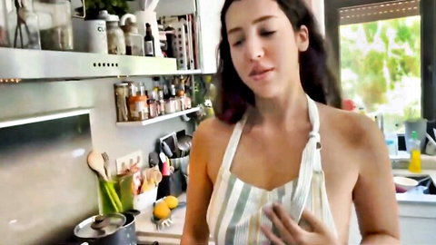 Alya Ferrari teasing in open apron exposing breasts in kitchen