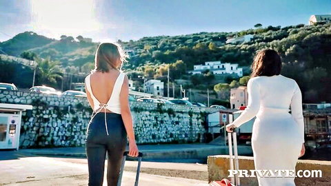 Two long-haired babes in tight white outfits walk seaside dock teasing curves for wild sex