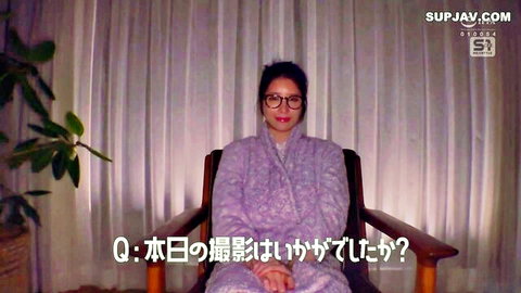 Asian brunette housewife in purple robe smiles during favorite sex position interview