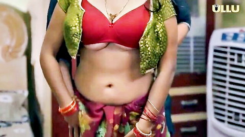 Sexy Indian woman in green blouse and red skirt showing deep cleavage
