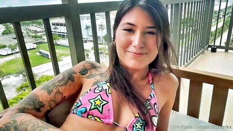 Charlotte Mae in pink star bikini on balcony, smiling POV tease