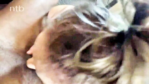 Mystery blonde woman in intimate side embrace with man
