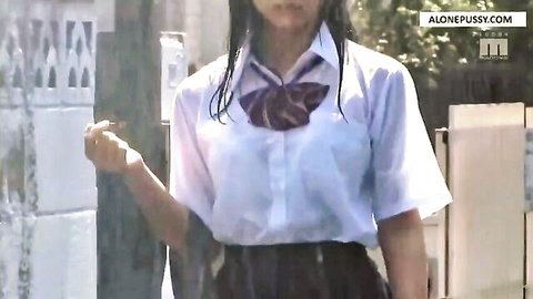 Wet Japanese schoolgirl in soaked see-through shirt and skirt posing outdoors