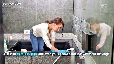 Sexy East Asian MILF in tight jeans bends over scrubbing black bathtub in steamy bathroom