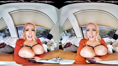 Blonde MILF with huge tits spilling from orange top spreads legs smiling in VR POV