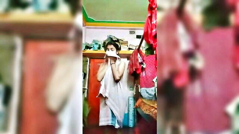 Sexy Indian teen babe in white towel wiping face in homemade bathroom