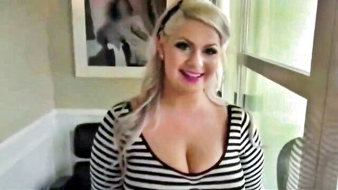 Busty blonde MILF smiles teasing huge tits in deep cleavage striped dress