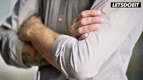 Tattooed man arms crossed in gray shirt, promo for rough sex with Arya Fae