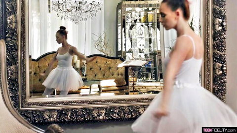 Sexy teen ballerina in tight white leotard and tutu poses elegantly in luxurious mirror room
