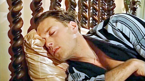 Vintage handsome hunk sleeping in bed with open shirt exposing chest