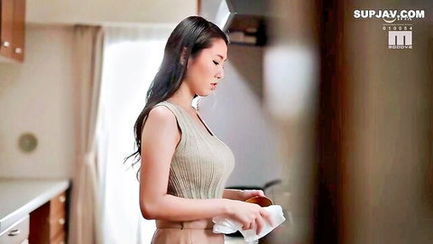 Hikari Sena in form-fitting beige tank top, teasing cleavage in kitchen