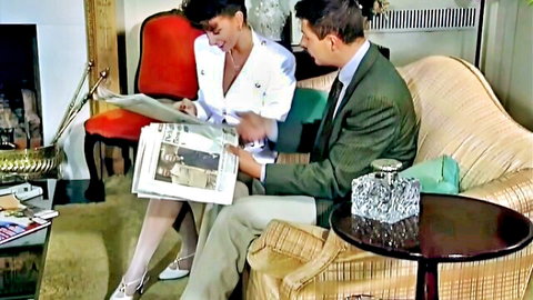 Sarah Young in white blouse and stockings teases suited man on couch