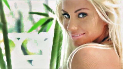 Sarah Summers blonde with green eyes smiling, showing cleavage in white top