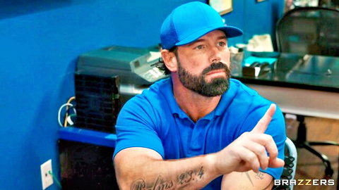 Bearded muscular man in blue cap and polo points teasingly in Brazzers scene