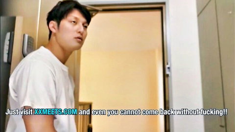 Young Asian man in white t-shirt leaning casually in doorway, intriguing glance