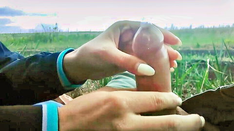 Ukrainian amateur handjob in the field, woman holds erect penis outdoors