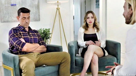 Young long-haired blonde in short skirt during tense couples therapy with husband and therapist