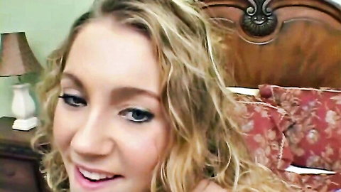 Smiling blonde young student in steamy bedroom scene