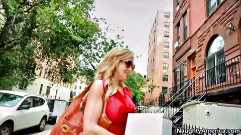 Brandi Love in sexy red dress and sunglasses walking urban street