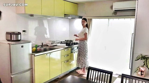 Curvy Japanese MILF housewife cooking in floral skirt and tight blouse in sunny kitchen