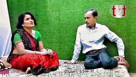 Curvy Indian MILF with big tits in green blouse and saree talks to older man on bed