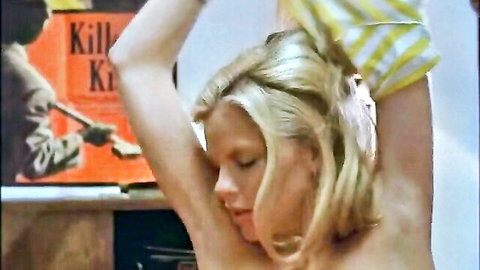 Vintage 1979 blonde topless woman raising arms in ecstasy pose