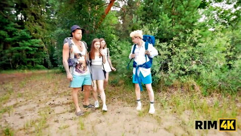 Sexy Russian babes in short skirts hike with studs through forest on outdoor adventure
