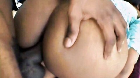 Black hand intimately caressing large white pregnant belly