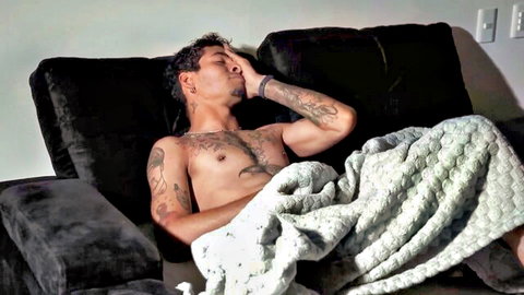 Tattooed muscular stepson lounging shirtless in Celeste Alba video, teasing taboo scene