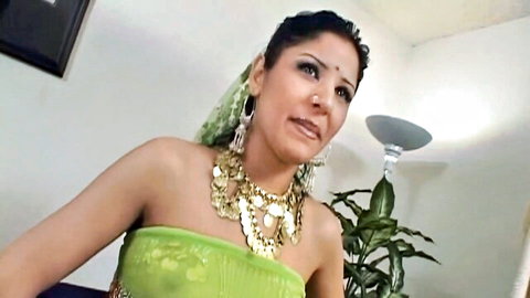 Seductive Indian woman in green blouse and gold jewelry, teasing gaze